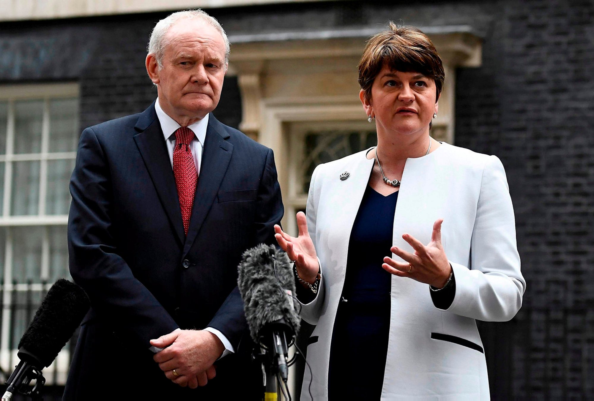 Arlene Foster (R) and Martin McGuinness, First and Deputy First Ministers of Northern Ireland, speak to journalists as they leave Number 10 Downing Street in London, Britain October 24, 2016. REUTERS/Dylan Martinez